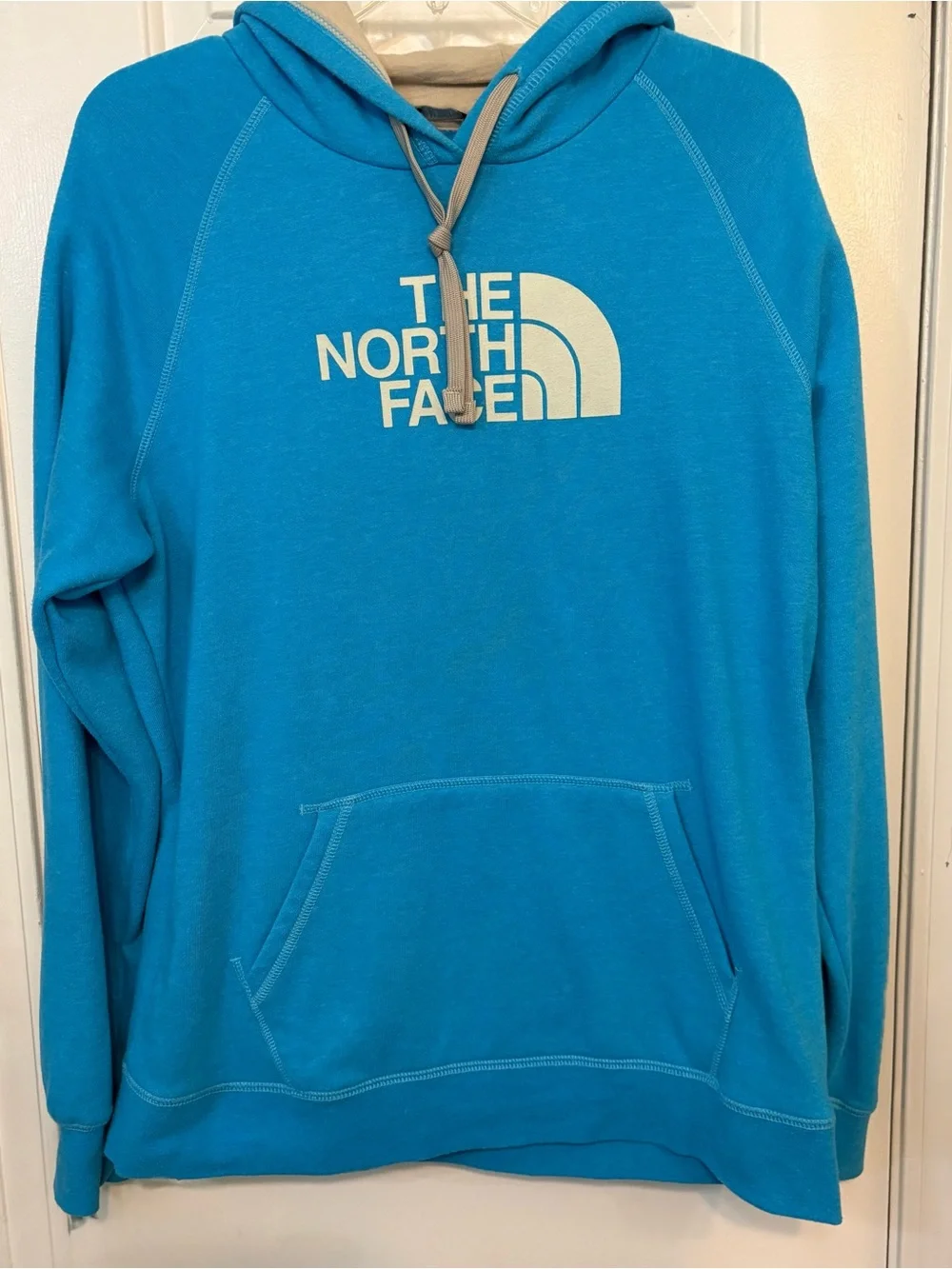 The North Face Turquoise Pullover Hoodie with Cream Logo